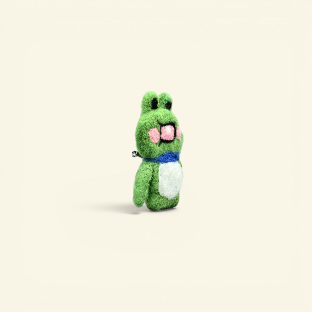 wool felt frog brooch detail — hand-needled collar and raised arm