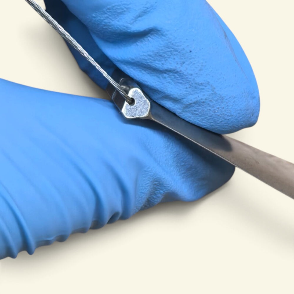 close-up of the steel wire loop threaded through the blade root, no drilled hole