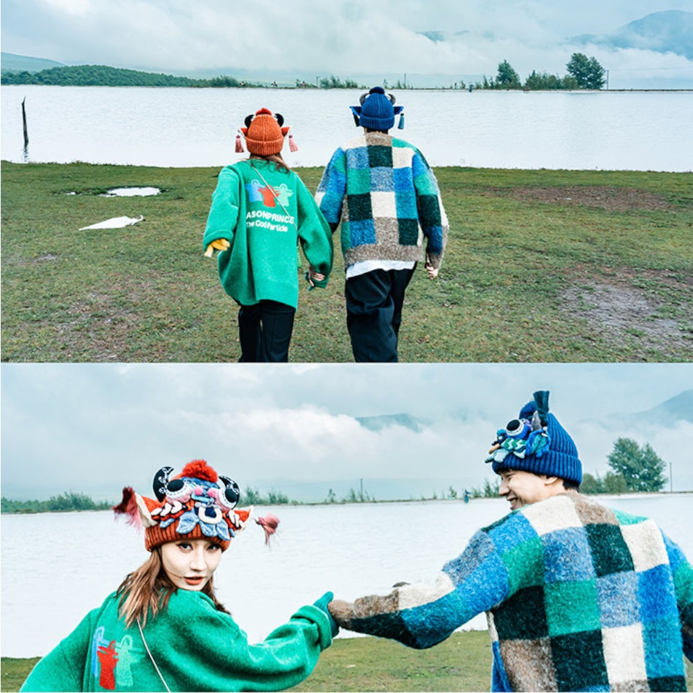 two photos of a couple by a lake, one wearing the red ox head beanie and the other the blue, holding hands, uggaz
