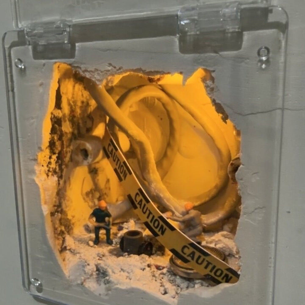 clear cover over a wall hole with a single tiny worker, caution tape draped over the cables like it just came down