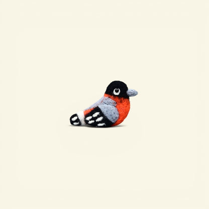 handmade wool felt bird brooch, firebelly colorway — orange chest, black head and gray wings, needle-felted in nepal