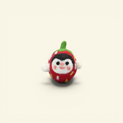handmade wool felt strawberry brooch — red and green with a peeking cream face, needle-felted in nepal