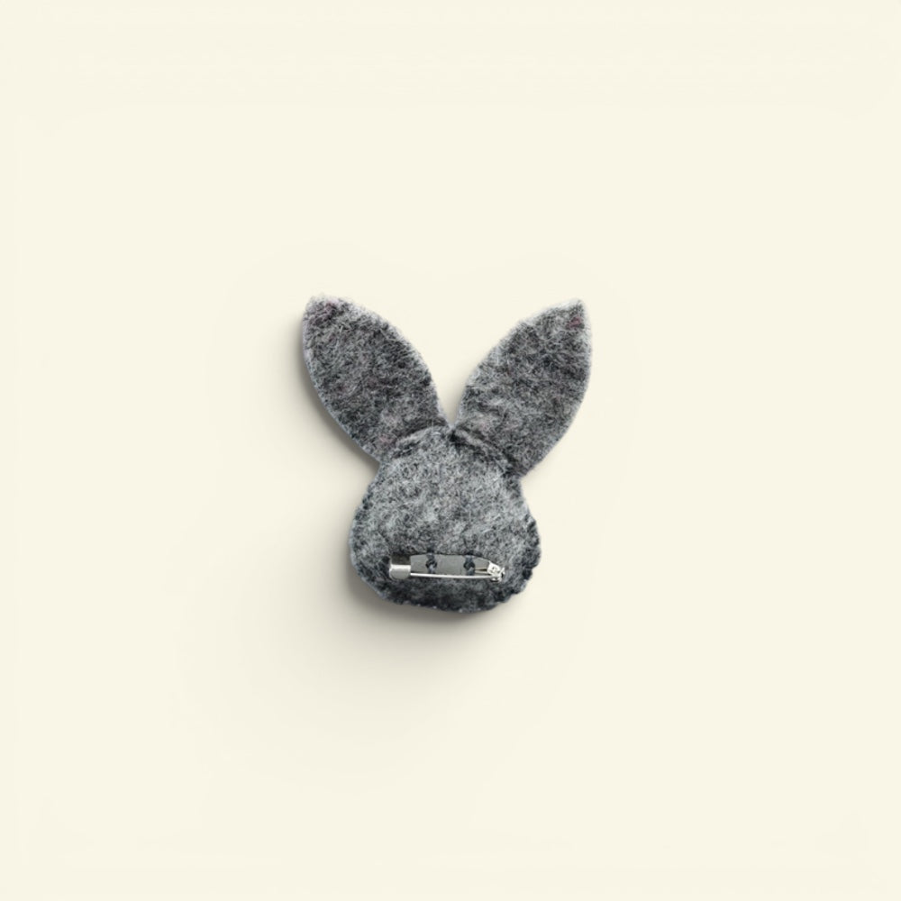 wool felt bunny brooch detail — stitched eyes, pink nose and hand-needled ears