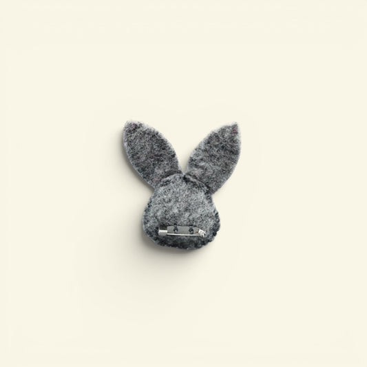 wool felt bunny brooch detail — stitched eyes, pink nose and hand-needled ears