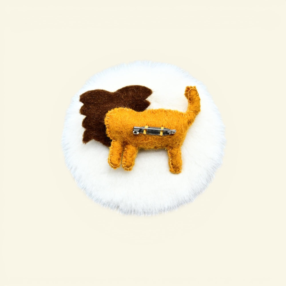 wool felt lion brooch detail — hand-needled mane and stitched face