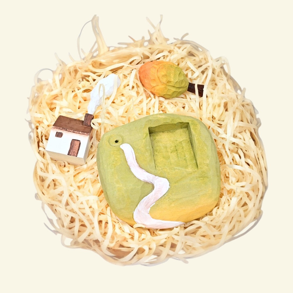 hand-carved and hand-painted basswood — each cottage varies piece to piece, no two alike