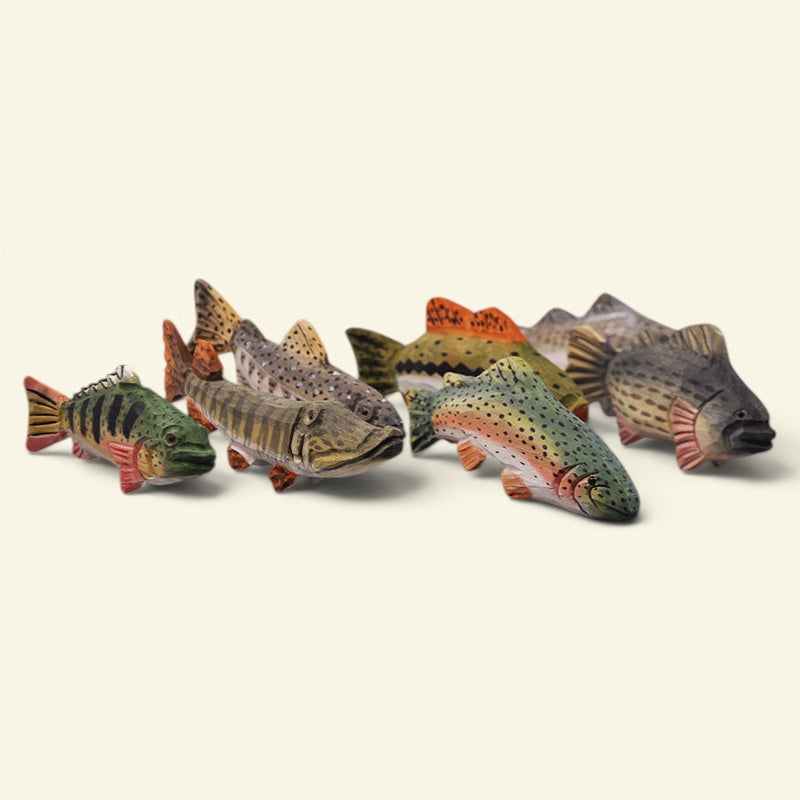 A set of five hand-painted wooden fish figurines representing different species of trout and salmon, arranged on a plain off-white background. uggaz