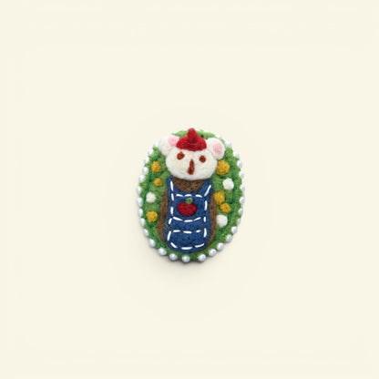 handmade wool felt bear brooch — cream and brown bear in a santa hat, framed in a pearl-edged cameo, needle-felted in nepal