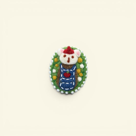 handmade wool felt bear brooch — cream and brown bear in a santa hat, framed in a pearl-edged cameo, needle-felted in nepal