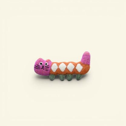 the felt house – wool felt long cat brooch, pink face and tail, orange body with white diamonds, uggaz