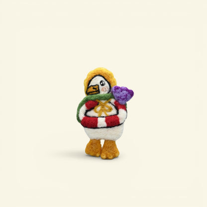 handmade wool felt sailor duck brooch — white and yellow with a red life ring and green scarf, needle-felted in nepal