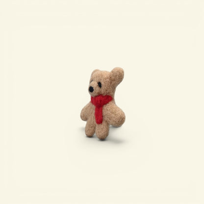 wool felt bear brooch detail — hand-needled fur and knotted red scarf