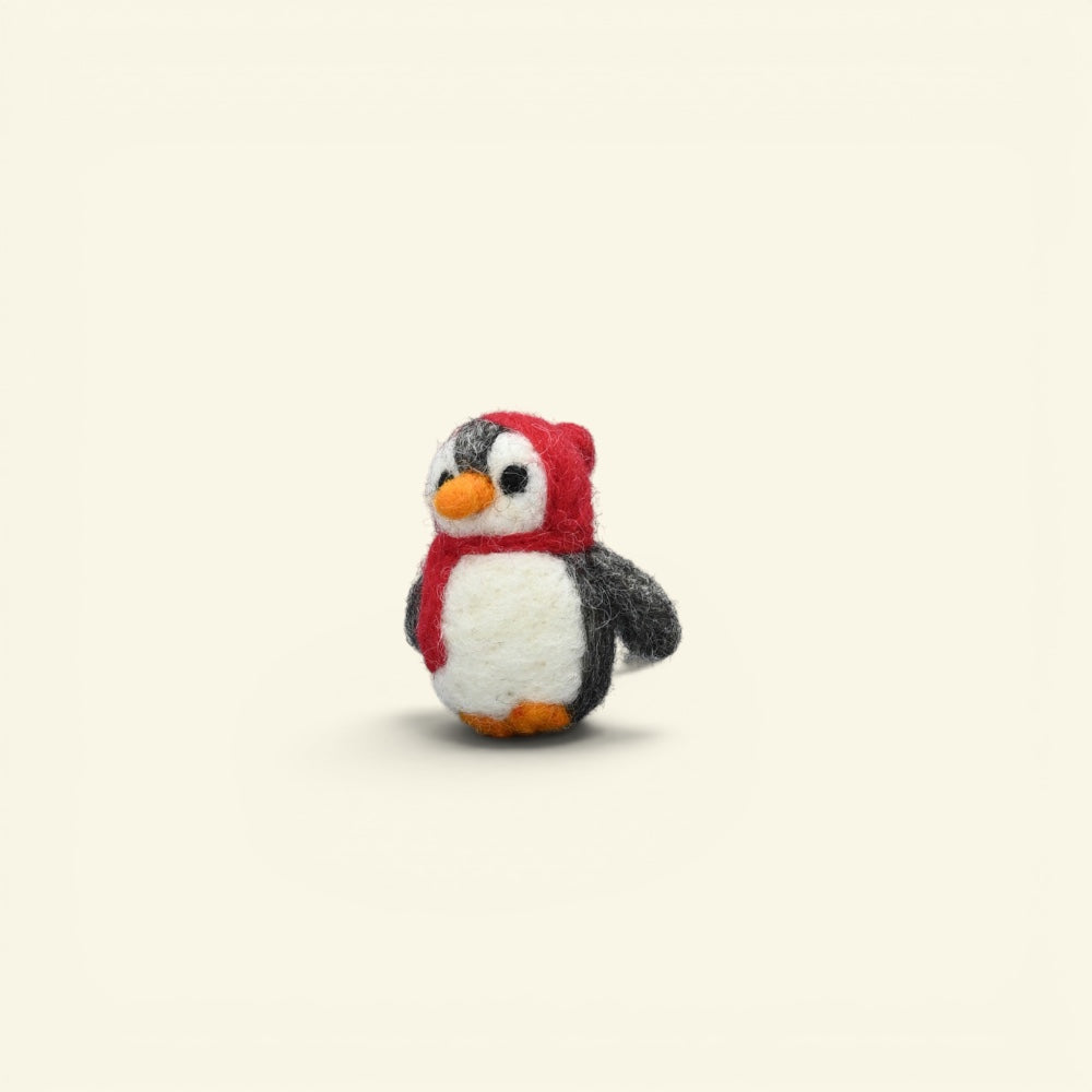 wool felt penguin brooch detail — hand-needled scarf and orange feet