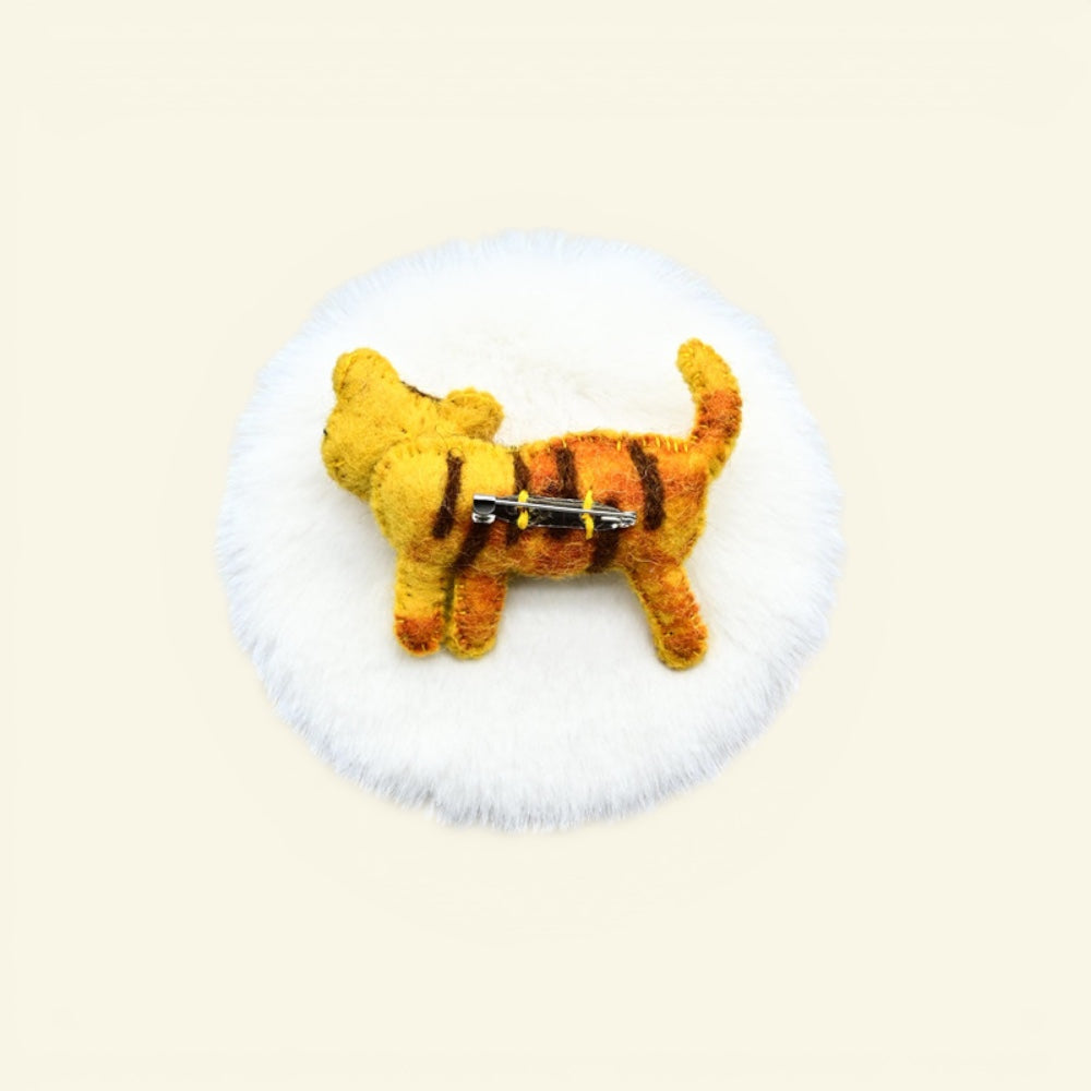 handmade wool felt tiger brooch — gold with dark stripes, needle-felted in nepal