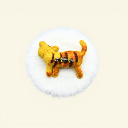 handmade wool felt tiger brooch — gold with dark stripes, needle-felted in nepal
