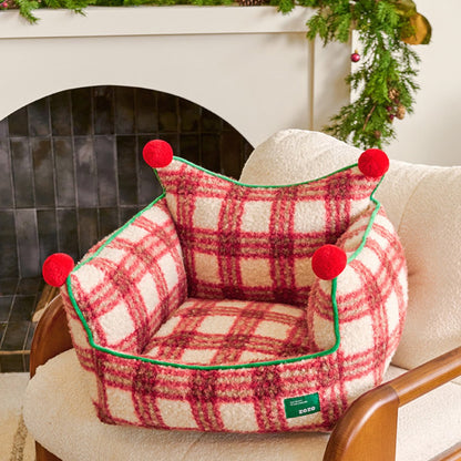 the plaid throne red plaid pet bed sitting on an armchair in front of a fireplace with holiday garland