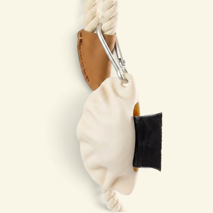the dumpling dispenser clipped to a rope leash handle via carabiner