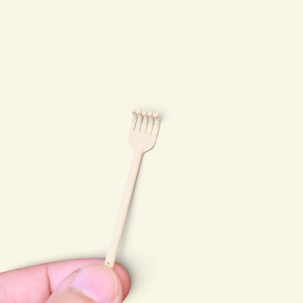 the tiny back scratcher balanced on a fingertip, cream 3d printed five-finger claw, uggaz
