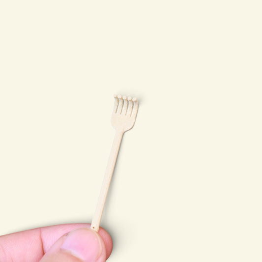 the tiny back scratcher balanced on a fingertip, cream 3d printed five-finger claw, uggaz