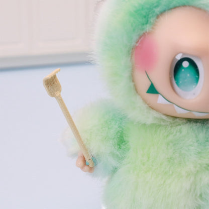the tiny back scratcher held up by a small plush toy, uggaz