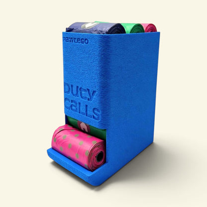 blue Duty Calls dispenser box with matching lid on, loaded with colorful bag rolls poking out the top, a pink polka-dot roll pulled partway out of the bottom slot