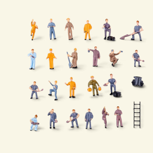 25-piece 1:87 worker set laid out on a cream background: 23 painted workers with shovels and tools, a ladder and a small cart