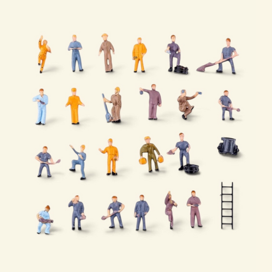 25-piece 1:87 worker set laid out on a cream background: 23 painted workers with shovels and tools, a ladder and a small cart