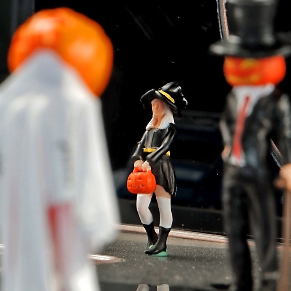 close-up of the 1:64 little witch holding her pumpkin bucket, with the pumpkin-head ghost and mr. pumpkin out of focus on either side