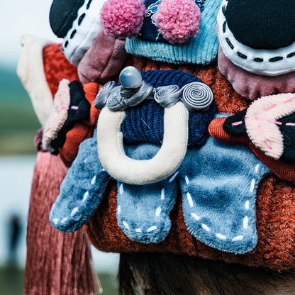 close-up of the ox head beanie's face in red — horns, pompoms, and wooden toggle nose, uggaz