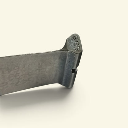 side view of the compressor blade root, showing the tiny air hole the wire passes through