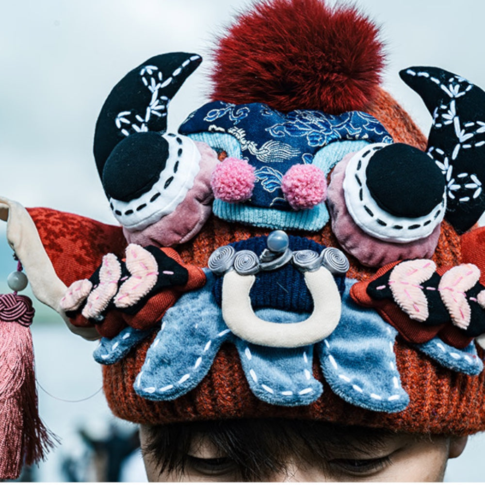close-up of the ox head beanie in red worn on someone's head, cropped from above, uggaz