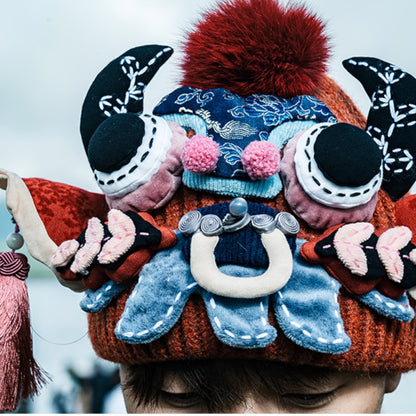 close-up of the ox head beanie in red worn on someone's head, cropped from above, uggaz