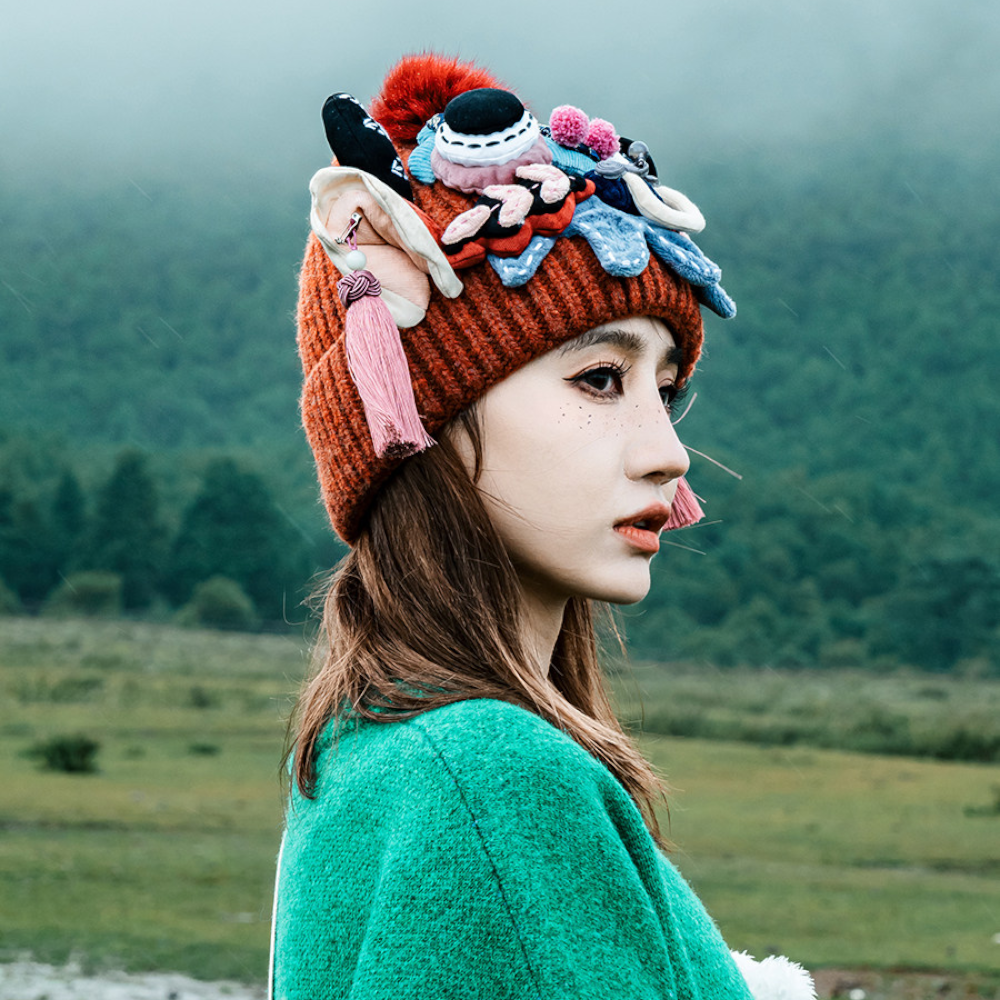 the ox head beanie in red worn in profile, foggy field in the background, uggaz