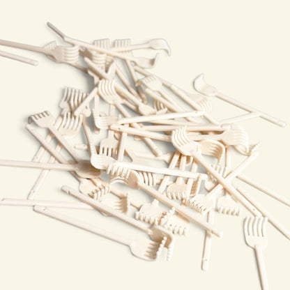 a pile of cream 3d printed miniature back scratchers, uggaz