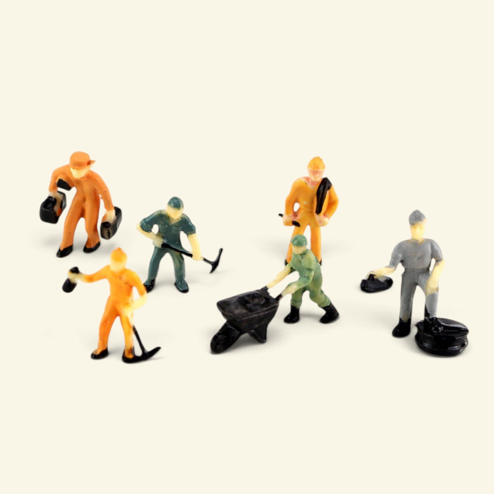 1:87 workers with a wheelbarrow, pickaxes and tyres on a cream background