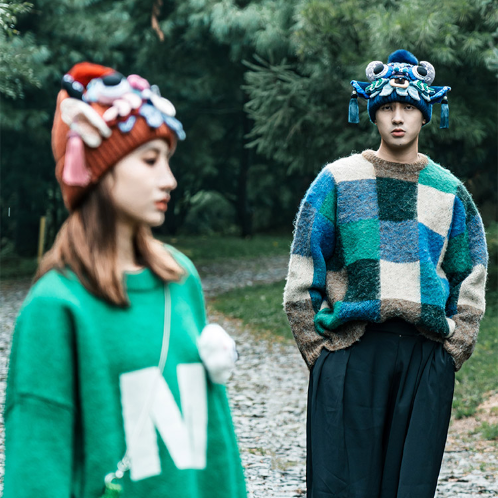 a couple walking outdoors, one wearing the blue ox head beanie and the other the red version, motion blur, uggaz