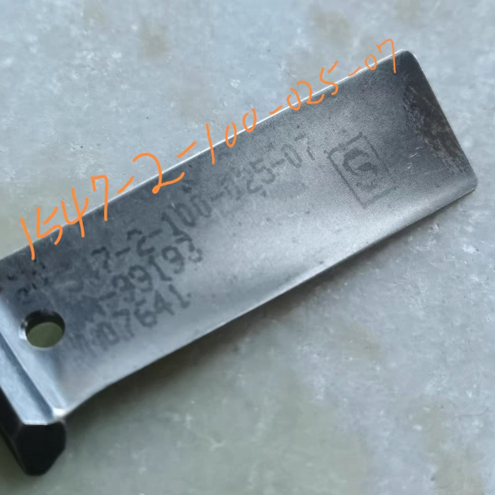 close-up of a marked blade from the same batch, stamped with part number 1-547-2-100-025-07 — the unmarked kind has this stamp polished off