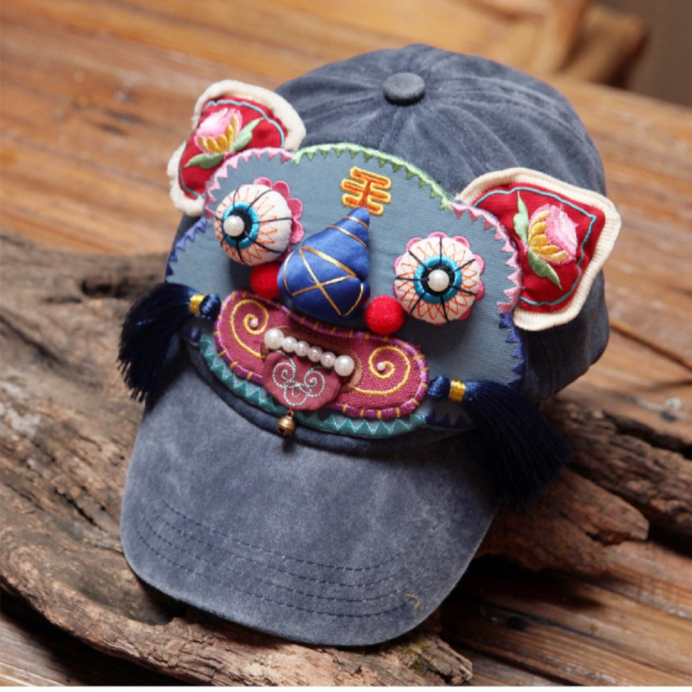 the tiger head cap at a three-quarter angle on driftwood, showing the brim and full tiger face, uggaz