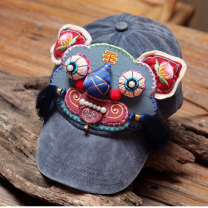 the tiger head cap at a three-quarter angle on driftwood, showing the brim and full tiger face, uggaz