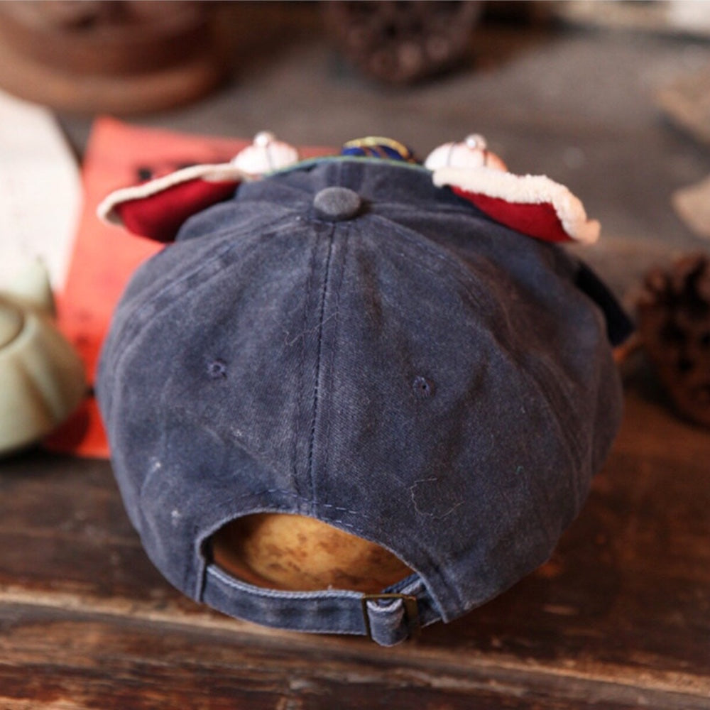 the tiger head cap from behind, showing the adjustable fabric strap and metal slide buckle, uggaz