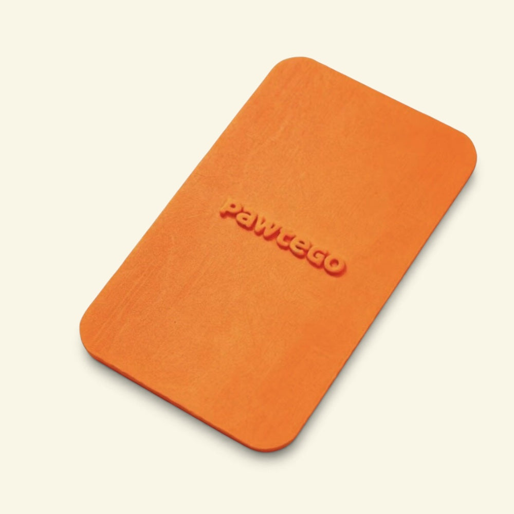 orange Duty Calls lid on its own, top-down view showing the embossed Pawtego logo