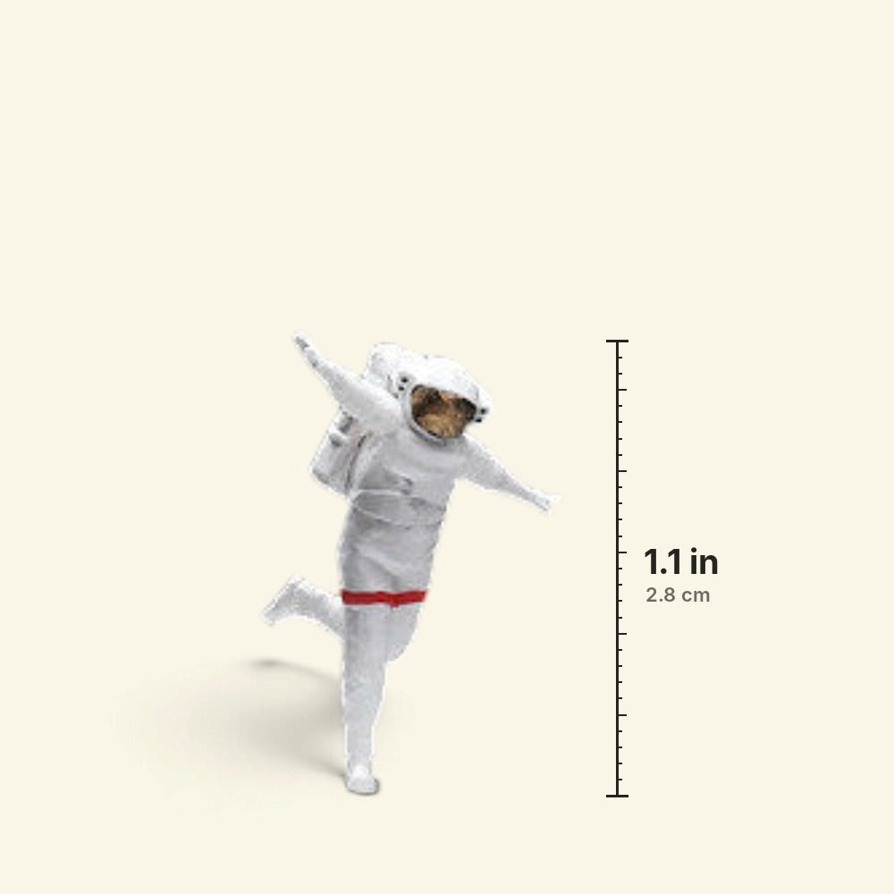 the happy astronaut 1:64 figurine next to a ruler: about 1.1 in / 2.8 cm tall from helmet to foot