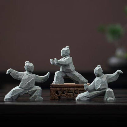 the slow masters – three tai chi figurines, one displayed on a carved wooden stand, uggaz