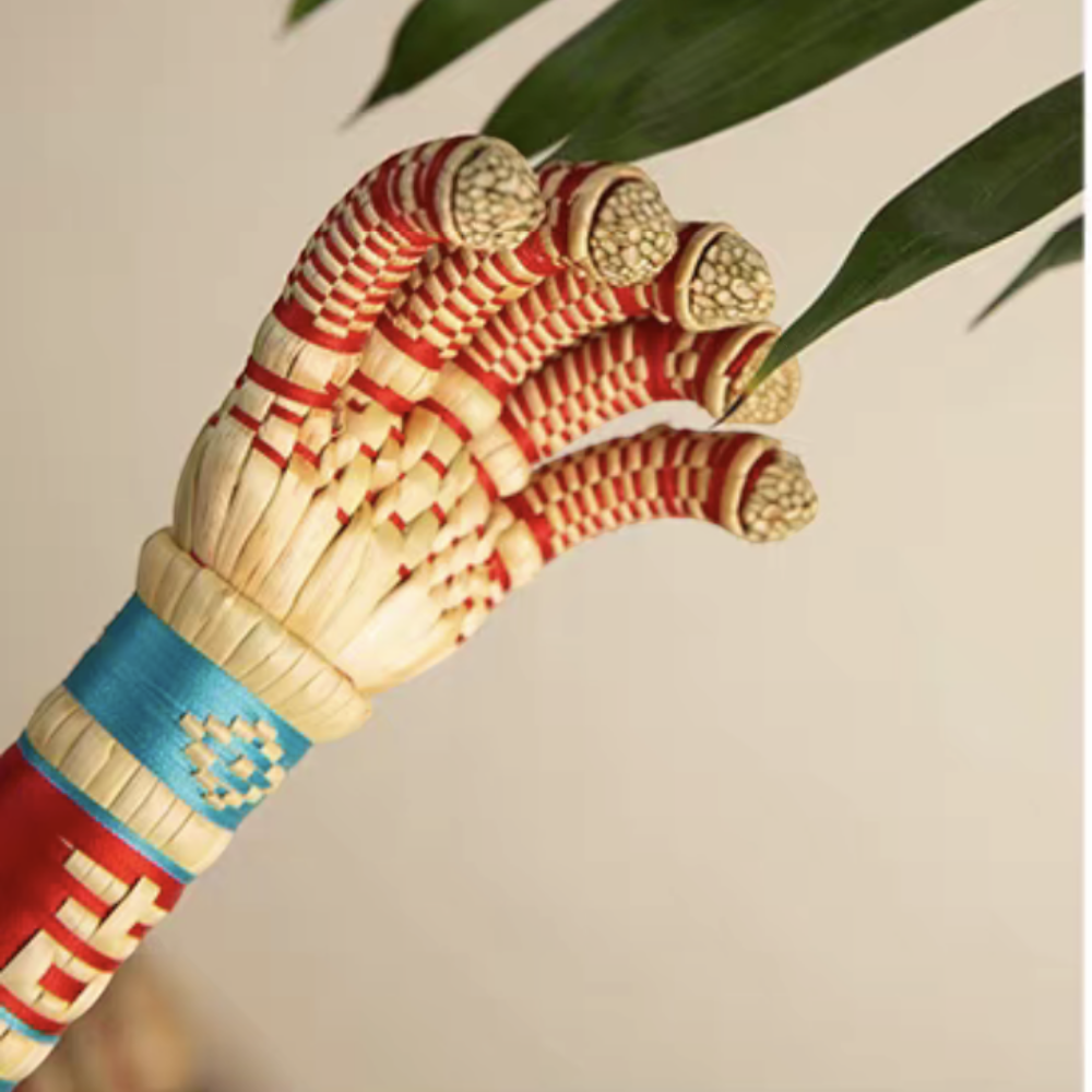 close-up of the sorghum hand's woven claw tips beside a green leaf, uggaz