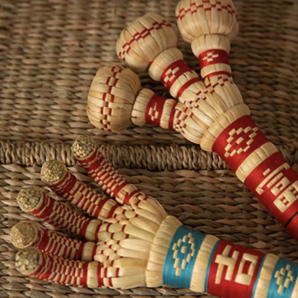 sorghum-stalk claw and knuckle hammer heads laid together on a woven mat, uggaz
