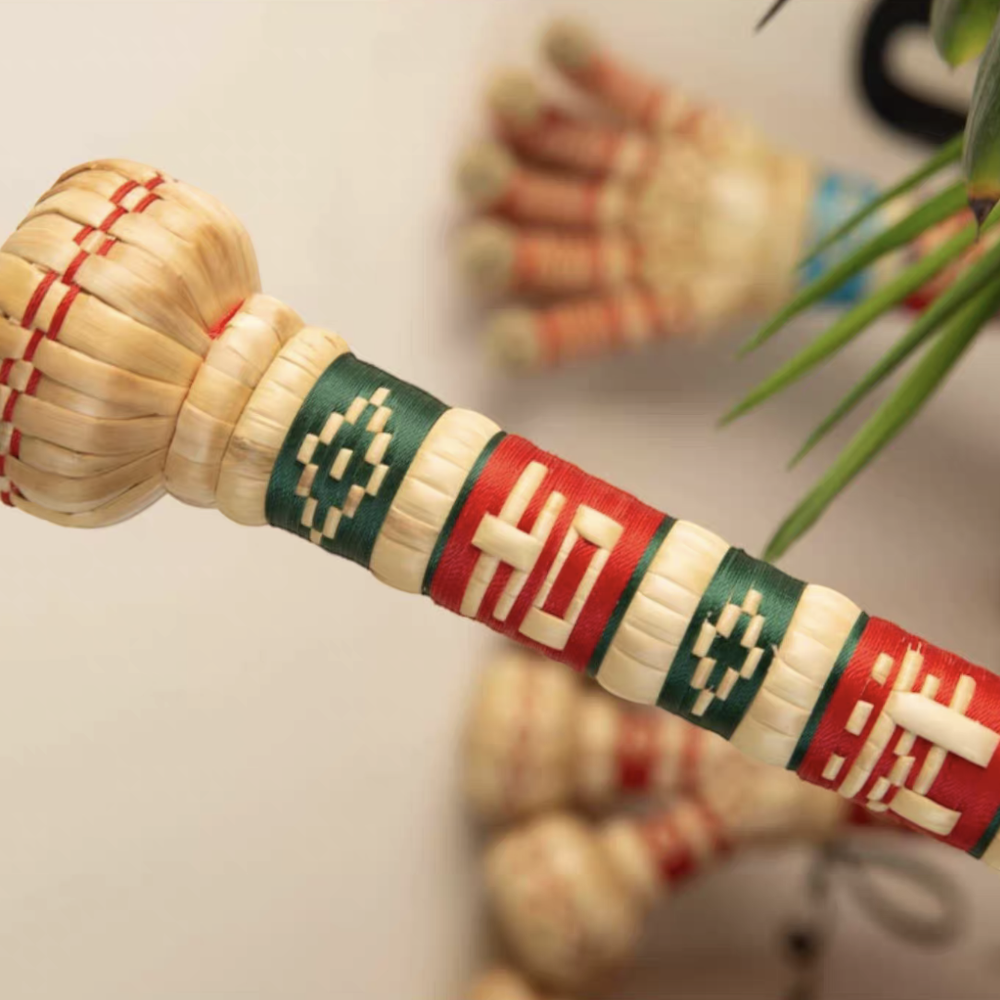close-up of the sorghum hammer's single-head knuckle and woven lucky character, uggaz