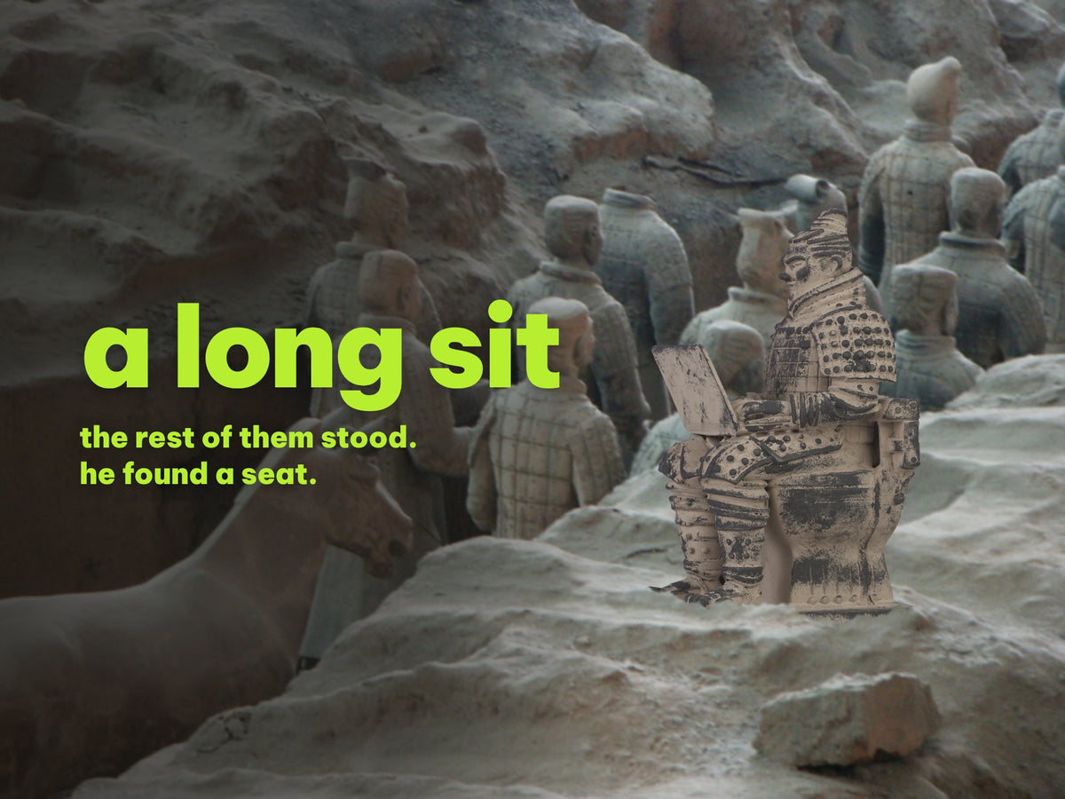 a terracotta warrior figurine sitting on a toilet with a laptop, half-buried in the dirt of an excavation pit while rows of terracotta soldiers stand behind him