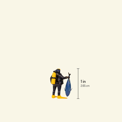 the diver, 1:64 scale resin figure, back view with yellow air tank, holding a tuna — about 1 in / 2.65 cm tall